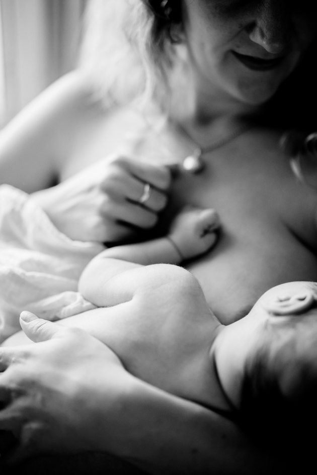 Nursing mother having photography session in-home 